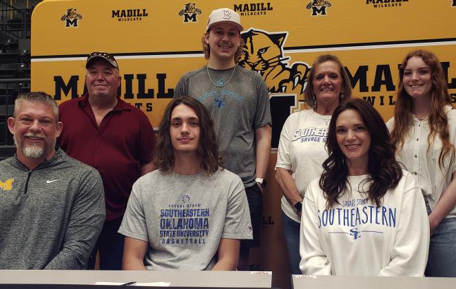 Ethan Wilkerson, center, signed his college letter of intent to play basketball for Southeastern while surrounded by his family and coach. Courtesy photo