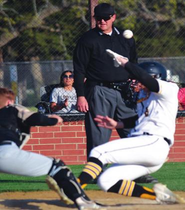 Ty Rushing slides into home plate during a Madill Wildcat Baseball game. Summer Bryant • The Madill Record