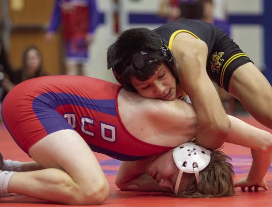 Pictured left: Madison Barrow pins Malorie Day. Pictured right: Brayden Valles gets the technical fall against Jacob Briggle. Matt Swearengin