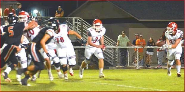 Lori Robinson • The Madill Record Redskin Brandon Watson #33 gets the short pass, as Tanner Showalter #34, Kolton Daniel #78 and Matthew Hawkins #20 work together to keep the Sperry Pirates at bay.