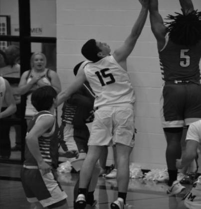Hayden Harper tries to keep the ball from going into the basket during the Madill v Plainview game. Summer Bryant • The Madill Record