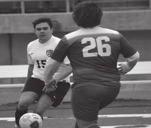 Miguel Garcia kicks the ball down the field during the Madill v. Atoka game on March 2, 2021. Summer Bryant • The Madill Record