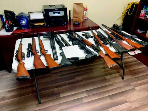 After Zachary Lawson barricaded himself in the house, officers gained entry and found 17 firearms and over 7,000 rounds of ammo. One of the firearms was reported stolen out of Kansas.