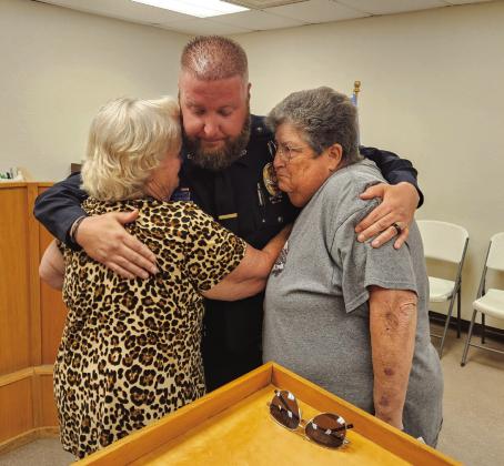 Kasey Cox is embraced after the Kingston Council voted to terminate him as police chief during a meeting last week. Matt Swearengin