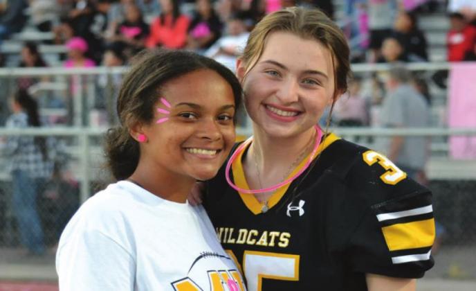 Autumn Bryant, left, poses with Molly Coleman, right. She was the honorary football captain and got to do the coin toss. Summer Bryant • The Madill Record