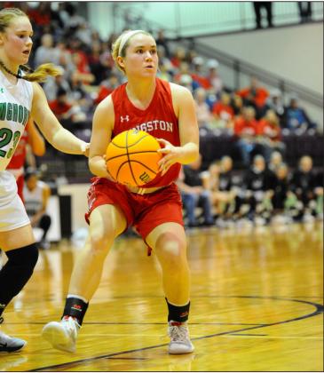 Kingston’s Emi Osteen (12) evades a Jones defender during the teams’ March 6 game in Chickasha. Jones, the #2 ranked team in Class 3A won the game 51-39. Crockett Uber • The Madill Record