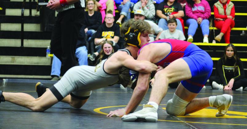 Wildcat Landon Clutter fights a Durant Lion during the wrestling meet. Summer Bryant
