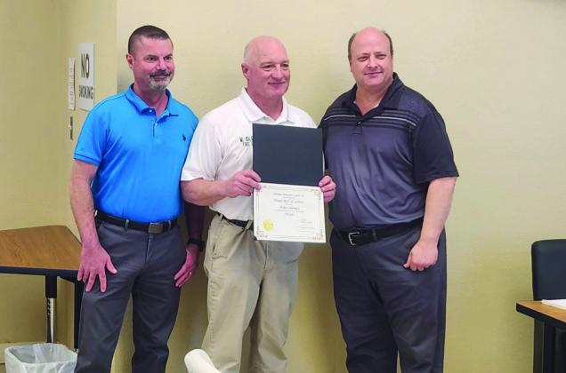 Madill Fire Chielf Mike Idleman, pictured center, was awared the 25 Years of Service Award. Madill City Manager James Fullingim, left and Madill Mayor Travis Williams, right stand with Idleman. Photo courtesy of Andrea Dunlap