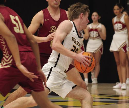 Greg Padgett dribbles past the opponents during the Madill v. Byng game. Courtesy photos