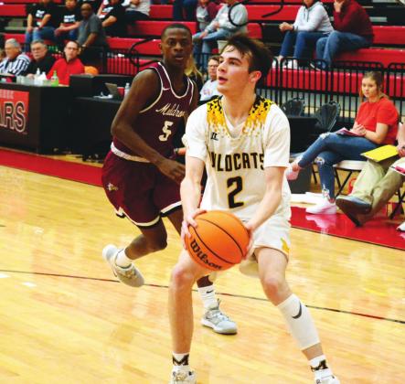 Madill senior guard Wyatt Gray (2) ponders a shot as a Muldrow player watches in their game Feb. 28. Tony McSwain • The Madill Record