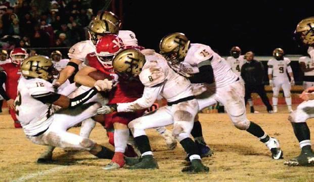 Tony McSwain • For The Madill Record Kingston sophmore running back Brandon Watson fights off several Hugo defenders during their game on Nov. 22. The Redskins beat the Buffaloes 22-12 and will face Sperry next.