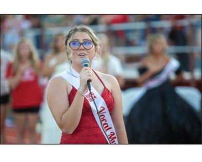 Kingston Homecoming Queen candidate Joscelin Hoffpauir sings the National Anthem before the start of last Friday's Redskins football game. Matt Swearengin