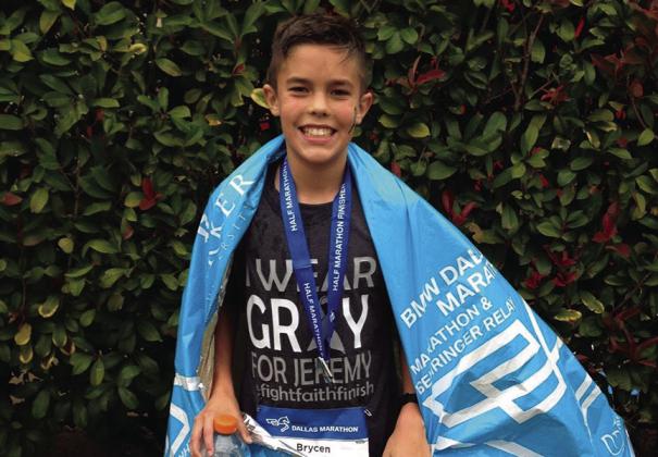 Brycen Ward, age 11, after his first half marathon - the race that hooked him on running. Courtesy Photo.