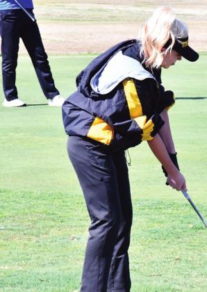 Kellani Lowe lines up for an approach shot during the tournament on March 23, 2021. Summer Bryant • The Madill Record