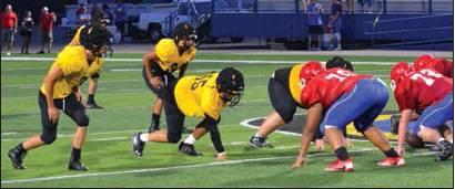 Photo by Matt Caban • The Madill Record The Madill Wildcats await a snap by the Durant Lions in a scrimmage August 23 at Paul Laird Field in Durant. Madill head football coach Todd Vargas said his defense held Durant in check although the hosts have a big offensive line.