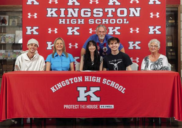 Jay Burns, pictured left with family, and Trinity Davis, pictured right with family, both signed to attend Southeastern Oklahoma State University for band. Courtesy photos