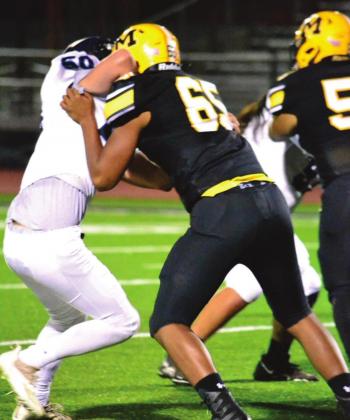 Summer Bryant • The Madill Record Bryce Coles pushes through the line of scrimmage during the Senior Night game on November 5, 2021. The Wildcats ended their season with an epic win of 55 to 6.