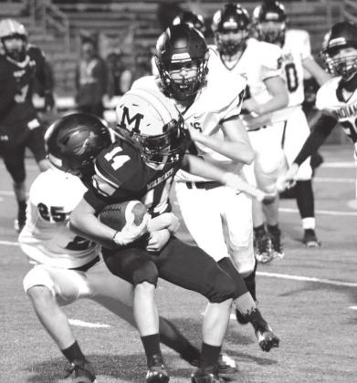 Summer Bryant • The Madill Record Josh Mann fights off two Little Axe linemen.