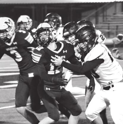 Summer Bryant • The Madill Record Blayze Adams looks back to try and catch a pass while fighting off the opponents.