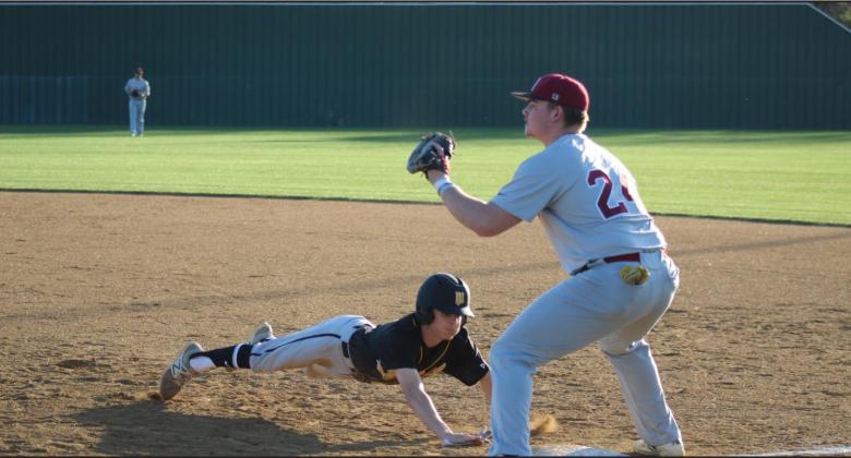 Wylbe Roberts makes the pitch as a Marlow runner is leading off of first base. Glenn Price • The Madill Record
