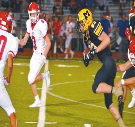 Holden MaGahey runs through a line of Durant Lions. He scored the second touchdown of the game during the fourth quarter. Summer Bryant • The Madill Record