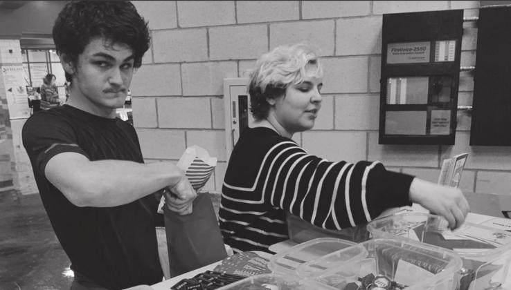 Angela Cutter sets up goodie bags with an unnamed helper. Megan Moss