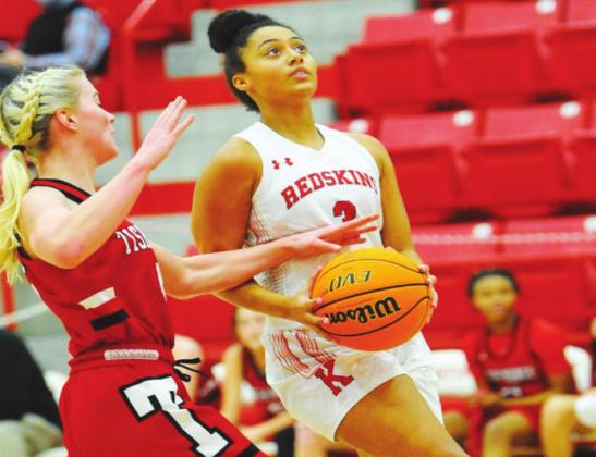Kiera Price goes head-to-head with a Tishomingo Indian during the February 2 game. Lady Redskins beat the Indians 55 to 22. Crockett Uber