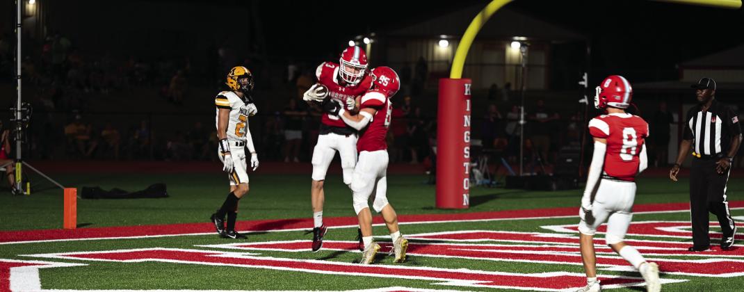 Kingston junior Eli Oliger and teammates celebrate after he scored the second touchdown of the game. The Redskins beat the Wildcats by one point in double OT during the Marshall County Super Bowl, earning the Redskins the right to paint the train trestle red. Courtesy photo