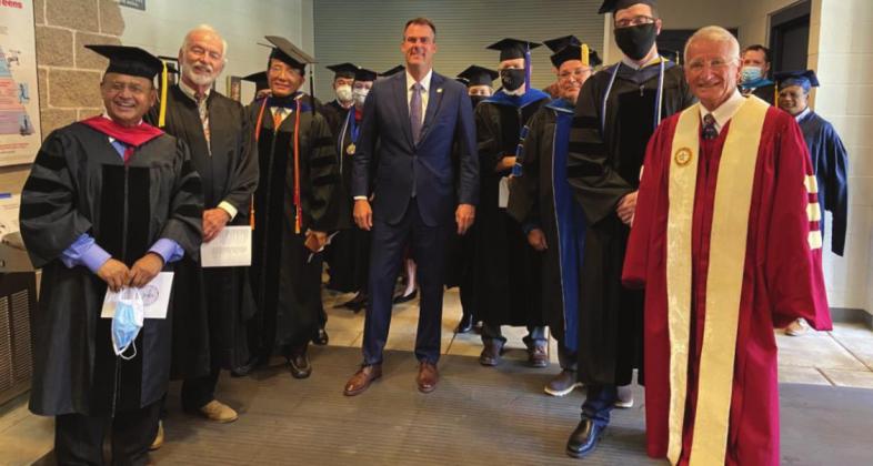 Before speaking at the Oklahoma School of Science and Mathematics' Convocation on Sunday, Governor Stitt poses with trustees and faculty. In his remarks, the governor inspired students to pursue their dreams. Fazlur Rahman, Ph.D., Ron Mashore, Mark Li, Ruibo Li, Ph.D., Sara Marie Bodenstein, M.Div., Governor J. Kevin Stitt, Monique Baxter, Kurt Bachmann, Ph.D., Michael Jordan, Ph.D., Brent Richards, Ph.D. and, Dan Little. Courtesy photo