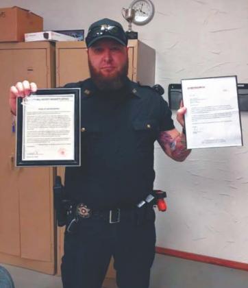 Above: Deputy Kasey Cox is presented with his letter of commendation by Marshall County Sheriff Danny Cryer. Below: Deputy Kasey Cox poses with his letter of commendation and certificate from Stop Stick. Courtesy photos