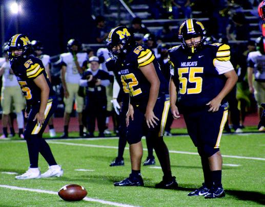 The Wildcats line up at the line of scrimmage. Summer Bryant