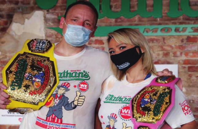 Competitive eaters Joey Chestnut and Miki Sudo after winning their respective divisions with new world records at the Nathan’s Famous Hot Dog Eating Contest on Saturday. Chestnut at 75 hot dogs in 10 minutes, winning him his 13th title. Sudo ate almost 49 dogs to snag the women’s title. Courtesy photo