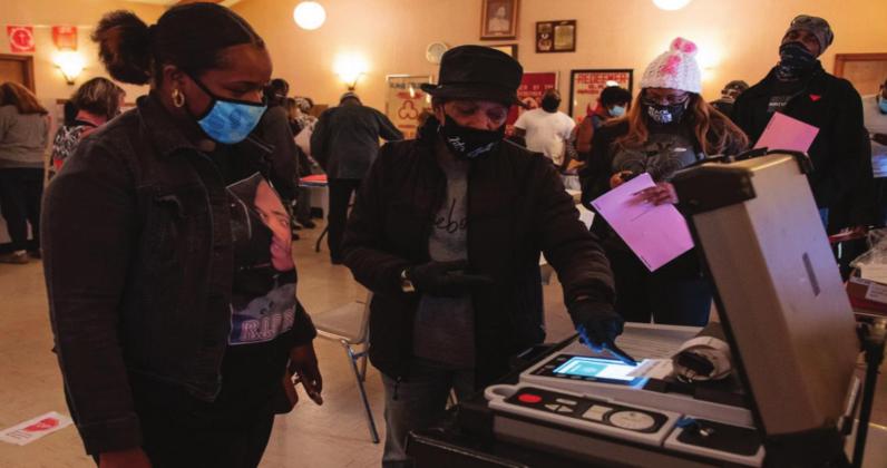 Poll worker Joyce Mayo shows voter Akeia Harrison, 20, that her ballot was counted at the Church of the Redeemer in Oklahoma City, which hosted voters from one of the bluest precincts in the state on Tuesday, Nov. 3, 2020. Whitney Bryen • Oklahoma Watch