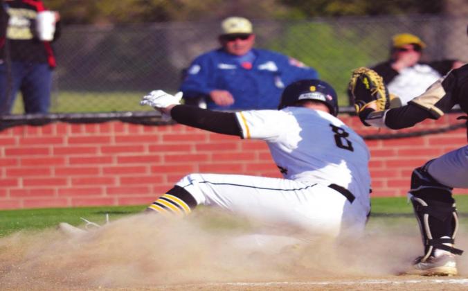 Ty Rushing slides into home plate among quite a bit of dust. The Wildcats won all three games on March 29 and April 1, 2021. Summer Bryant • The Madill Record