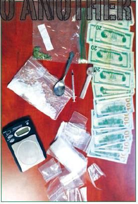 Cryer located a used syringe that was in plain view of the officers. They also discovered numerous syringes, small Ziplock baggies, a digital scale.
