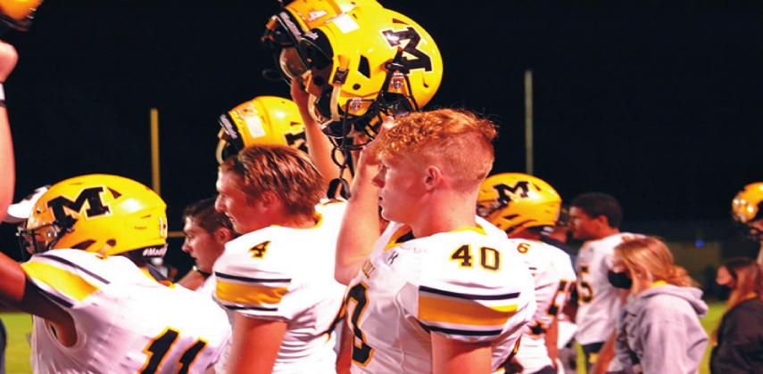 Junior Trevor Merrit, #40, Sophmore RJ Morris, #11, Junior Kendall Robertston, #4, and the rest of the Wildcats celebrate a big win against the Marietta Indians. They beat Marietta 42-14 on September 11, 2020. Summer Bryant • The Madill Record