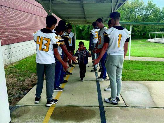 The Wildcats give high fives and fist bumps to elementary students. Courtesy photo