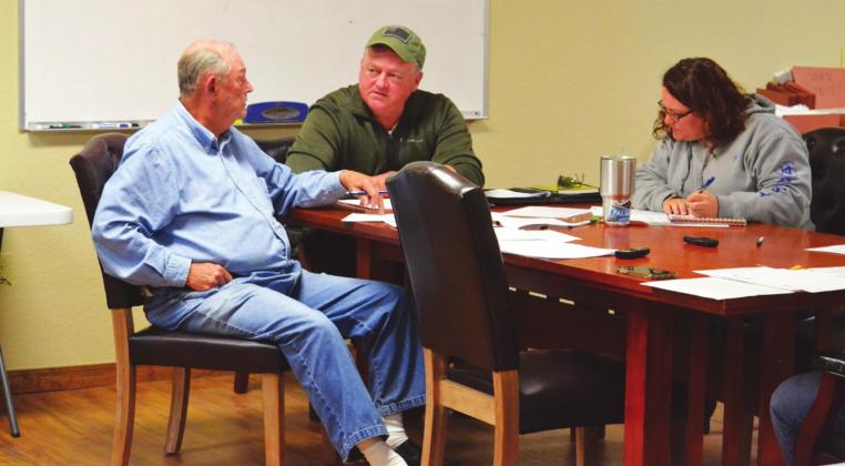 Marshall County EMS Board member Roy Methany and Chairman Darren Alexander, and Elizabeth Wainwright discuss amendments. Matt Caban • The Madill Record