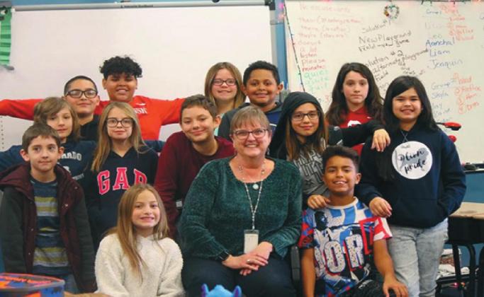 “I’m going to miss the kids of course and the creativity of coming up with lessons that will engage them. It’s hard,” said former Lincoln Elementary School teacher Anne Ham, shown here in January with her fifth-grade students in Norman. Ham decided to retire one year early because of health concerns stemming from COVID-19. (Courtesy Anne Ham) Courtesy photo