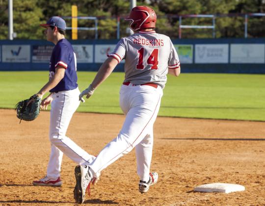Blane Henry runs to first base. Matt Swearengin