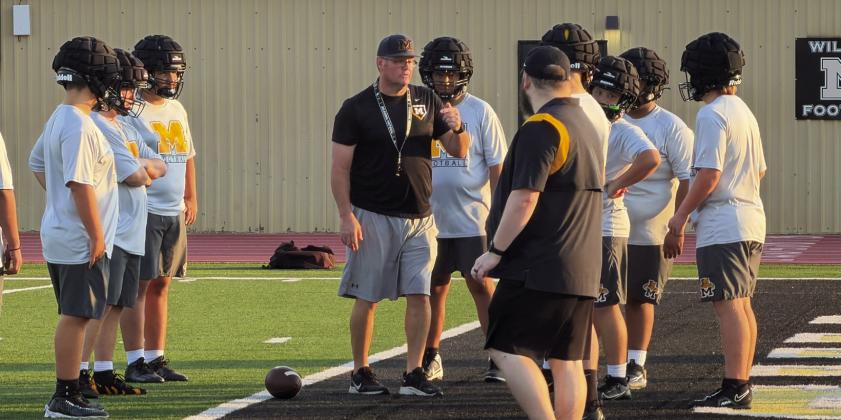 MHS Football Coach Wigington instructs his players during their scrammage. Courtesy photo
