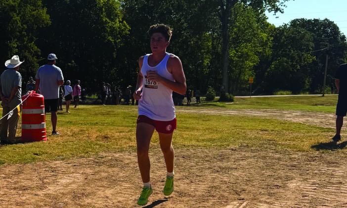 Pictured top left: The starting line at the Running with the Herd Cross Country Meet. Pictured top right: Everett Eason took 7th place in the meet. Pictured below: The KMS Cross Country starting line. Courtesy photos