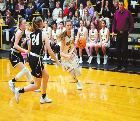 Madill junior Abbie Lambertsen (right) dribbles past a pair of Lone Grove defenders during the team&amp;#x2019;s game Jan. 28 at Madill High School. The Lady Wildcats claimed a 45-42 victory in overtime. The win, on basketball homecoming night, moved them to 10-7 for the season. Tony McSwain &amp;#x2022; The Madill Record