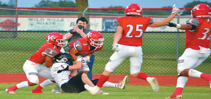 Kingston senior Jarron “Boomer” Morgan (#3) wrestles an interception away from Tishomingo’s Justin Cardenas (#5) along with senior Coltin Robinson (#1) in coverage. Summer Bryant • The Madill Record