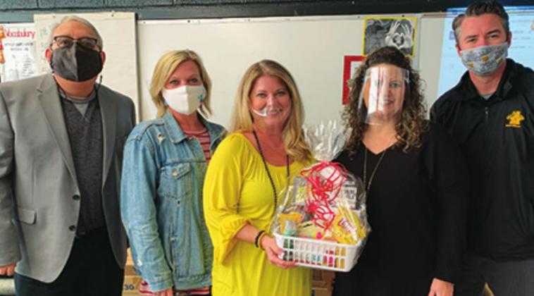 Shanda Burnett (yellow shirt) was named Madill Middle School’s Teacher of the Year. Larry Case, Jamea Gilbert, Gaylynn Pierce and Brett Weiberg presented her with a gift. Courtesy photo
