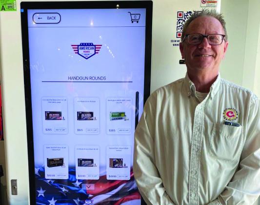 Super C store manager Jim Dowling stands next to the ammo kiosk. Courtesy photo