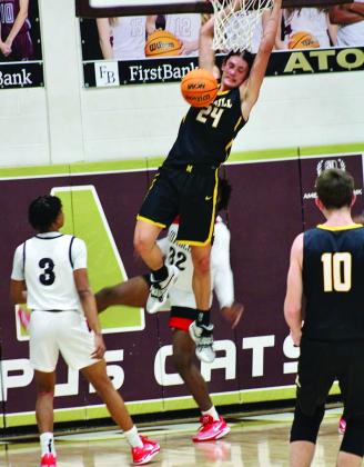 Ethan Wilkerson goes up for a slam dunk during the Wampus Cat Classic Championship. Photo by Summer Bryant