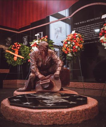 An image of the bronze statue, &#x201C;We Will Remember&#x201D; inside Gallagher Iba Arena at Oklahoma State University. OSU commissioned noted Western sculptor, Harold Holden of Kremlin, Oklahoma, to create a symbol of the university&#x2019;s loss and commitment to remember ten friends taken too soon. Among them was Jared Weiberg, younger brother of Brett Weiberg, MHS boys basketball coach coach. Courtesy Oklahoma State Athletic Department