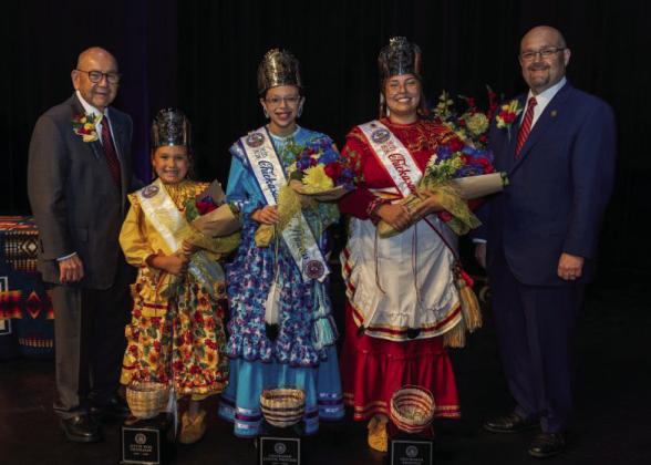 Three talented young ladies were crowned 2025-2026 Chickasaw Princesses during the 2025 Chickasaw Annual Meeting and Festival. From left, Chickasaw Nation Governor Emeritus BillAnoatubby with Little Miss Chickasaw Paeson Baken, Chickasaw Junior Princess Taylor Komalty, Chickasaw Princess Kaley Reed and Chickasaw Nation Governor Chris Anoatubby. Courtesy photo