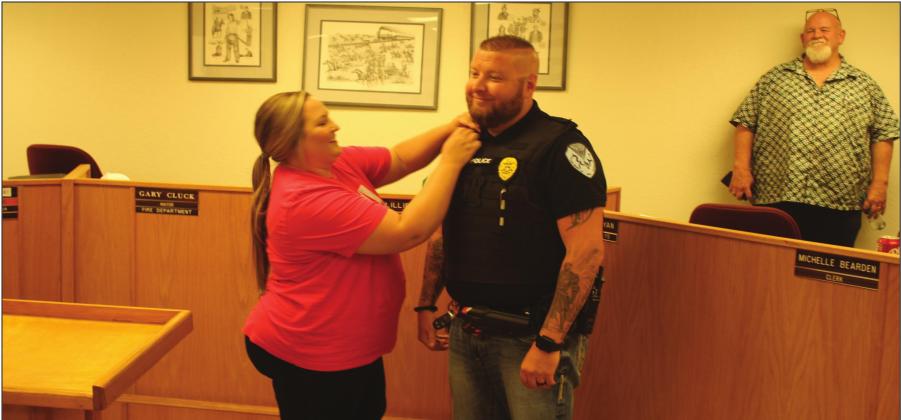 Kingston Police Chief Kasey Cox receives his chief pins from his wife, Rebekah Cox during the Kingston City Council meeting on July 12, 2022. Gary Jackson • The Madill Record
